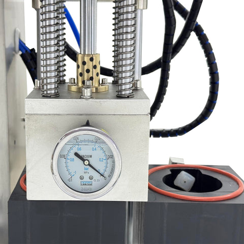 Close-up of No Sweat Automatic Vacuum Bottle Capper With Responsive Foot Pedal And Smart Touchscreen gauge and pneumatic components.