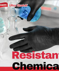 XL black nitrile exam gloves in lab, pouring blue liquid into glass beaker; chemical-resistant disposable gloves.
