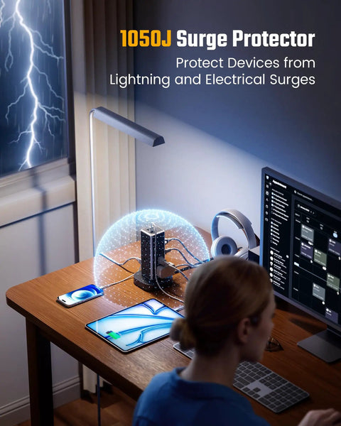 Heavy Duty Tower Power Strip Game Changing Surge Protection With Retractable Cable Featuring Twelve Wide AC Outlets Plus Four Fast Charging USB Ports For Easy Setup on a desk protecting devices.