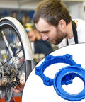 Lightweight Aluminum Center Lock Tool Adapter For Bicycles Disc Brakes next to mechanic adjusting bike wheel.