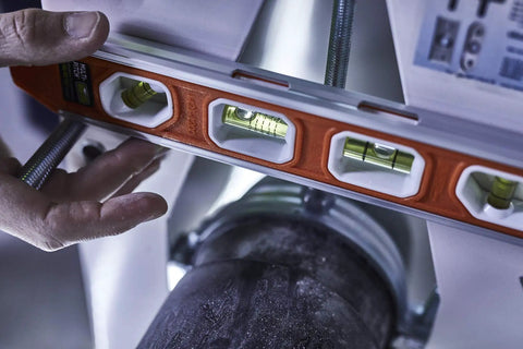 Close-up of Magnetic Aluminum Reinforced Torpedo Level 12 Inch Red With Hands Free Magnetic Edge and pro grade durability in use