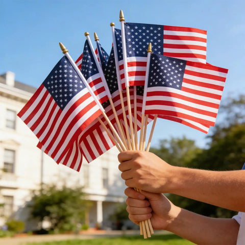 Hands holding 12 Pack Small American Flags 4x6 Inch Hand Held Stick Flags With Safety Spear Top for outdoor patriotic events and decor