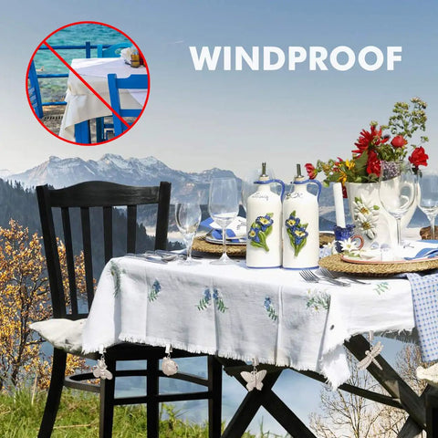 Outdoor table with 4 Pack Tablecloth Weights With Metal Clips Clamps For Outdoor Parties And Picnics, in butterfly shapes.