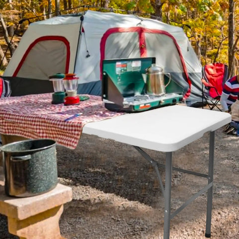 Heavy Duty 4 Foot Folding Table For Indoor Outdoor Use With Handle Portable Square Dining Card Table Waterproof Durable Plastic Top 330 Lb Weight Capacity Ideal For Picnics Parties Camping And More displayed at a campsite with a tent and cooking equipment.