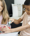 Child using Mini Box Cutter With Ceramic Blade Manual Retracting Safe Edge Opens Boxes Fast Mint Color Pack to open packaging