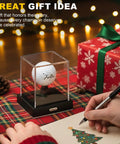 Clear Acrylic Golf Ball Display Case With Secure Locking System, Dustproof Cube Holder With Velvet Interior, on a table