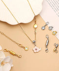 24 Pcs Magnetic Necklace Clasps Set In Round Cylindrical And Tubular Styles, Silver And Gold Finishes on a beige surface