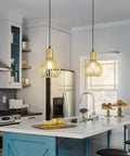 Gold Pendant Light Fixture With Adjustable Rope For E26 Bulbs in a modern kitchen over an island, enhancing a vintage farmhouse style.