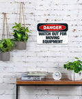 Heads Up Watch Out For Moving Equipment Aluminum Sign 8x12 Inch on brick wall above table with plants and clock