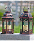 Two Pack Bronze Solar Lanterns With Ornate Retro Hanging Design on stone ledge outdoors