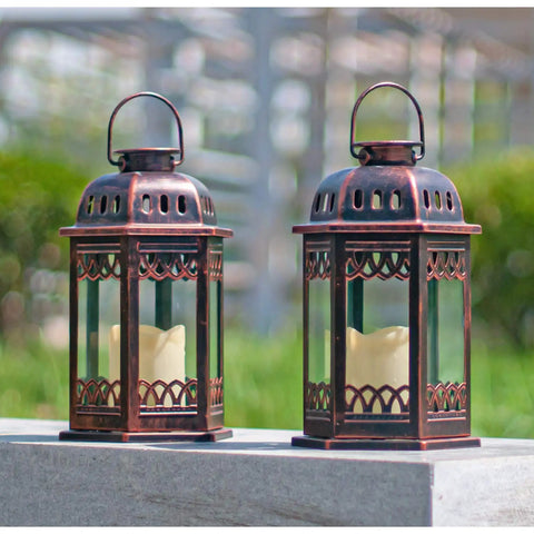 Two Pack Bronze Solar Lanterns With Ornate Retro Hanging Design on stone ledge outdoors