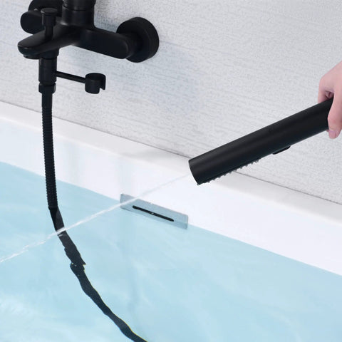 Wall Mount Bathtub Faucet With Handheld Shower And 59 Inch Hose Sleek Black Finish in use, showing water flowing into tub.
