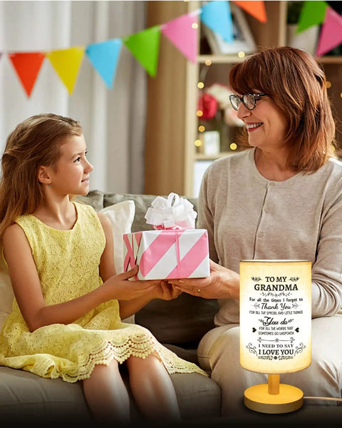 Grandma receiving fabric night light gift with warm white glow in cozy decor from granddaughter, heartfelt Nana Mimi birthday present