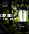 Ultra Bright LED Camping Lantern With 300 Lumens Battery Powered Water Resistant Emergency Light hanging in forest