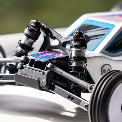 Close-up of Beefed Up Carbon Fiber Front Shock Tower and Aluminum Oil Shocks Upgrade on Losi Micro B RC Car with threaded preload