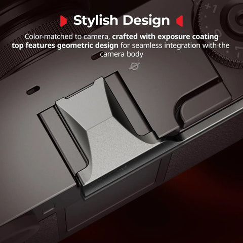Fujifilm X Half Thumb Grip With Anti Slip Textured Surface And Built In Silicone Pads For Stable One Hand Handling Charcoal Silver Finish Easy Hot Shoe Mount shown on camera close-up.