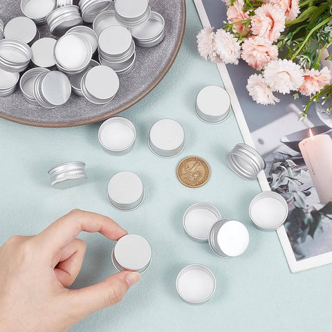 Image of 36 Pack Silver Aluminum Seal Screw Caps for Round Steel Tins with Plastisol PE Liner, various caps and a hand picking one.