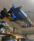 Heavy Duty Ceiling Storage Hooks For Garage Set Must Have, Overhead Rack To Hang Lumber, Ladders, Pipes, Fishing Rods, Bikes And Gear, Space Saving J Hooks, 2 Pack, Sturdy Ceiling Mounted Organizer installed with various items stored overhead.