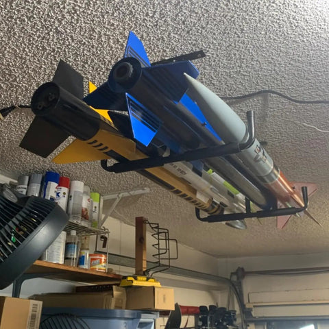 Heavy Duty Ceiling Storage Hooks For Garage Set Must Have, Overhead Rack To Hang Lumber, Ladders, Pipes, Fishing Rods, Bikes And Gear, Space Saving J Hooks, 2 Pack, Sturdy Ceiling Mounted Organizer installed with various items stored overhead.