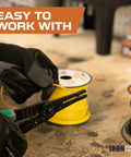 Person pulling yellow wire from spool, labeled 'Easy to Work With', 14 Gauge Primary Automotive Wire 1000 Ft Total In 10 Color Coded Roll Assortment Pack Copper Clad Aluminum Core PVC Insulated Flexible And DIY Ready For Home Or Automotive Wiring.