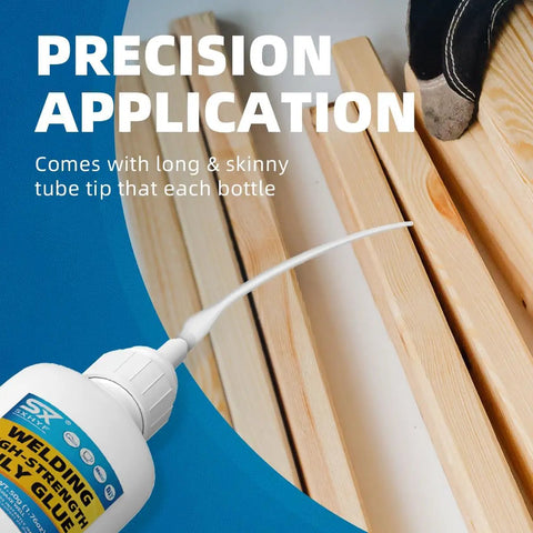 Close-up of a tube of welding high-strength super glue with precision application tip on wooden planks