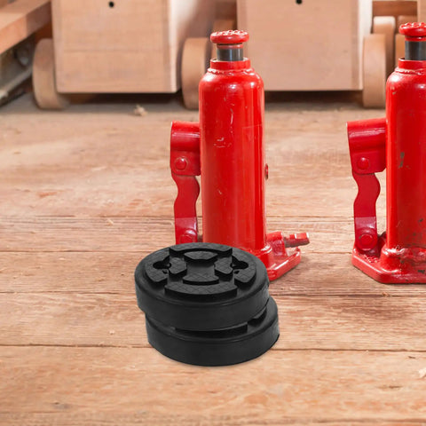 Vosarea Heavy Duty Car Lift Pads Set Of Four Round Auto Jacking Rubber Mats for Two Post Hoist placed near red jacks on wooden floor.
