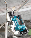 Compact 18V Cordless Brushless Portable Band Saw Featuring No Fuss Blade Setup Variable Speed Throttle And Rugged Aluminum Guide Rail in use on metal pipes.