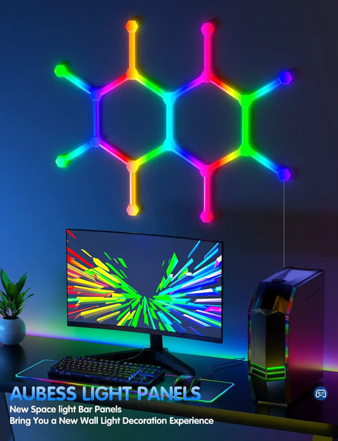 RGBW LED Wall Light Panels With WiFi Control Hexagon And Line Kit for gaming setup, glowing above a computer desk.