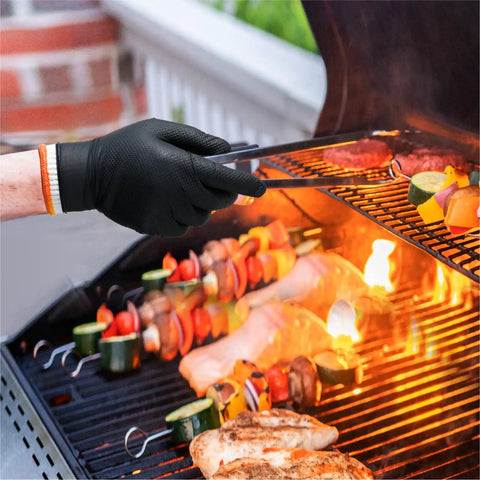 Person using Dual Layer Heat Resistant BBQ Gloves With Nitrile And Cotton Liners 10 Mil Thick Non Slip Grip For Grilling Smoking And Handling Hot Meat