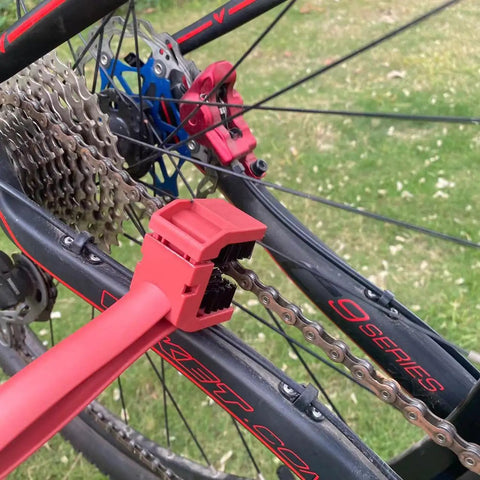 Bike Chain Cleaning Tool Set With Crankset Brush And Motorcycle Chain Cleaner Brushes in use on a bike chain, red plastic body.