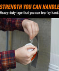 Person tearing heavy duty white duct tape 1.88 inch wide, 30 yard roll pack of 2, UV resistant, triple layer strength outdoors.