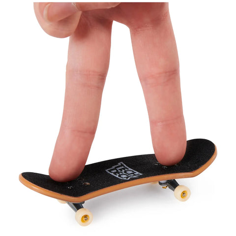 Close-up of fingers playing with a DLX Pro 10 Pack Fingerboards With Real Skate Graphics Fully Assembled Collectible Mini Skateboards Set