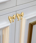 Dang Stylish Gold Bow Cabinet Handles Eight Pack Plus Heavy Duty Screws Easy Install Drawer Knobs For Dressers And Cabinets on white cabinet.