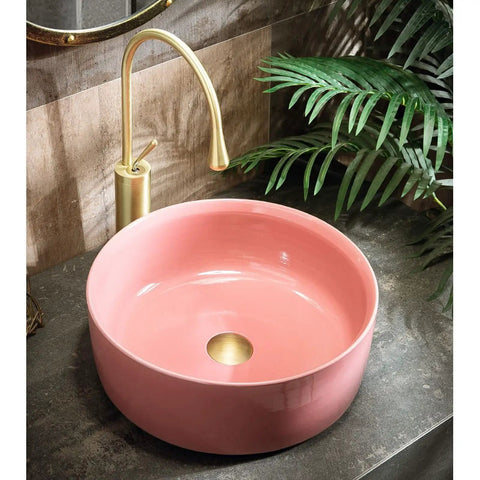 Top Shelf 15.7 Inch Round Pink Ceramic Vessel Bathroom Sink Over Counter Vanity Basin With Super Easy Pop Up Waste Kit Slick High Gloss Glaze Hits Different For Any Modern Home Space, shown from the side with faucet.