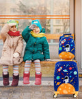 Two Piece Kids Luggage Set With 12 Inch Backpack And 18 Inch Rolling Suitcase In Blue Astronaut Design beside sitting children.