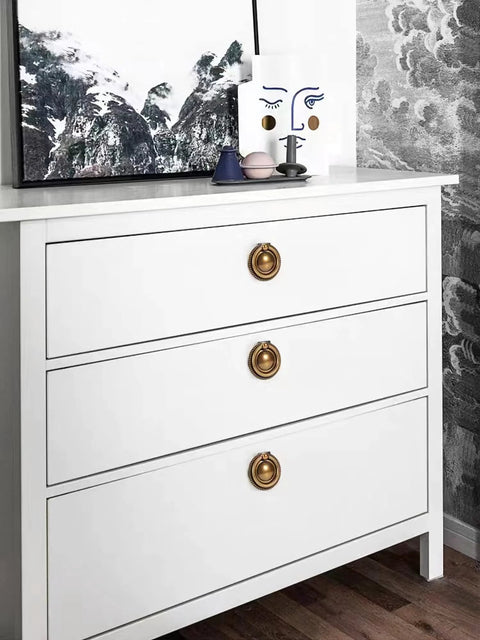 White dresser with 8 Pack 2 Inch Antique Brass Ring Drawer Pulls With Round Plate Base For Cabinets And Cupboards installed.