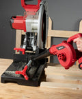 Compact 20V Cordless Mini Blower Kit With 150 MPH Air 62 CFM being used to clean sawdust from a workbench