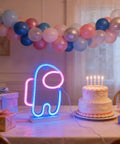 Lit Alien Neon Sign Light Astronaut LED Decor with cake and balloons, USB or Battery powered for party atmosphere.