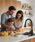 Matte Black Pull Down Kitchen Sink Faucet In Solid Stainless Steel With Single Handle Spray Head For Zero Drip Action And A Super Clean Modern Kitchen Glow Up Built Tough For Day To Day in a family kitchen scene with people preparing food.