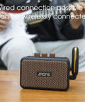 Aroma Mini 5W Guitar Amp With Clean And Overdrive Channels, Rechargeable Portable Electric Guitar Amp AG 04 on table