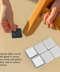 Applying 12 Piece Self Adhesive Furniture Sliders Set For Carpet And Hardwood Floors Reusable Glide Pads to chair leg.