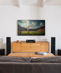 Living room with 7.2 Channel AV Receiver with Built-In HEOS and 8K HDMI Dope Wireless Streaming Dolby Atmos HDR10 Plus Dynamic HDR DTS X WiFi and Bluetooth Plug and Play Setup for Small to Medium Rooms and Smart Home Vibes on a wooden cabinet, surrounded by speakers.