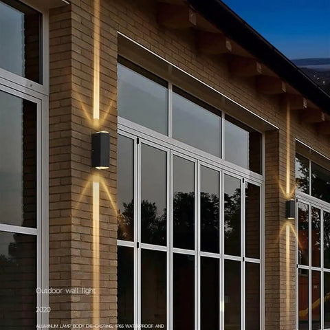 Modern Led Outdoor Wall Sconce,2-Pack 20w Updown Wall Wash Light,Black Metal Ip65 mounted on brick wall, illuminating entrance.