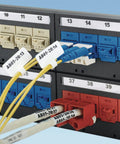 Panduit PSL-DCJB-BL RJ45 jack blockout device on a labeled patch panel with blue connectors and yellow cables