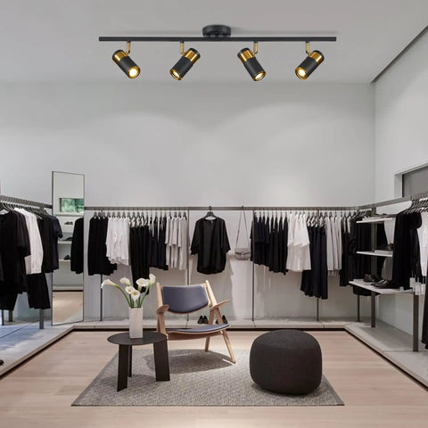 4 Lights Matte Black Track Lighting Fixture For Ceiling, Modern flush mount in a boutique setting with adjustable spotlight heads.