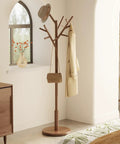 Solid Wood Coat Rack Freestanding Tree With 12 Hooks And 3 Height Levels Adjustable Coat Stand For Entryway Or Bedroom A Real Game Changer For Coats Hats Bags And Scarves Walnut Finish showing in a bedroom corner with items hanging
