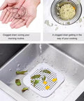 A Total Game Changer 3 Pack Silicone Drain Catchers For Sink And Tub Reusable Hair Strainers With Mesh Filter collecting debris in a kitchen sink.