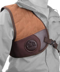 Adjustable Rifle And Shotgun Field Shield Recoil Pad with leather vest on model showing secure fit and cushioned design