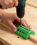 Premium Drill Guide Block For Dead On Straight Holes And Hella Accurate 45 And 90 Degree Angles in use with a drill on wood.