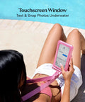 Woman using Waterproof Phone Pouch With Lanyard IP68 Floating Case For All Phones near pool, showcasing touchscreen on Lavender Holo pouch